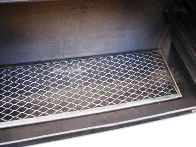 lower cooking grate inside of model 2040 smoker pit